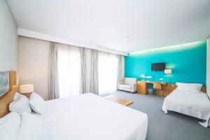 Кровать или кровати в номере Hotel Praia