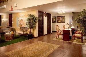 a living room with a table and a dining room at First Group Magalies Park in Hartbeespoort