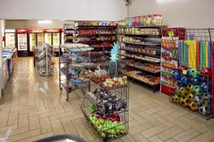 a store aisle with shelves of food and merchandise at First Group Magalies Park in Hartbeespoort