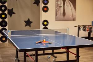 a ping pong table with scissors on top of it at First Group Magalies Park in Hartbeespoort