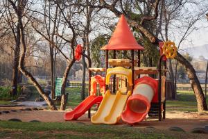 a playground with a slide in a park at First Group Magalies Park in Hartbeespoort
