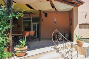 a patio with a table and chairs on a house at Vila Veche in Haţeg