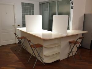 a bathroom vanity with two mirrors and two stools at IL CASTELLO HOSTEL BOUTIQUE in Bologna