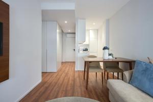 a living room with a table and a couch at Signature Apartments Santa Catarina in Porto