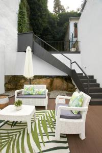 a patio with two chairs and a table and stairs at Signature Apartments Santa Catarina in Porto