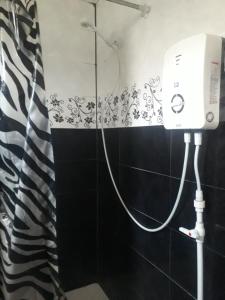 a bathroom with a shower with a hair dryer on the wall at Dzoragyugh B&B in Dzoragyugh