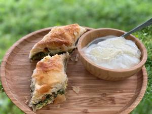 a plate with a sandwich and a bowl of dip at Peraj Guesthouse in Vermosh