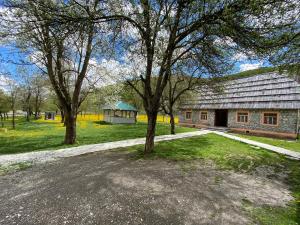 a group of trees in front of a building at Peraj Guesthouse in Vermosh