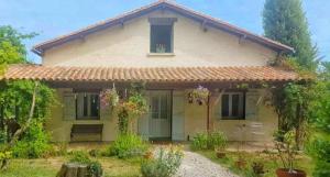 a small yellow house with a bench in front of it at Holiday Chalet 2 Set in Country side in Bouteilles-Saint-Sébastien