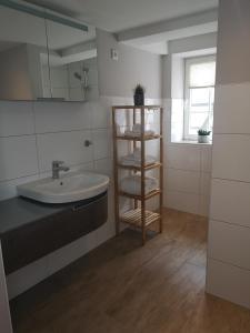 a bathroom with a sink and a mirror at Ferienwohnung Telemann Stadtmitte in Eisenach +11 photos