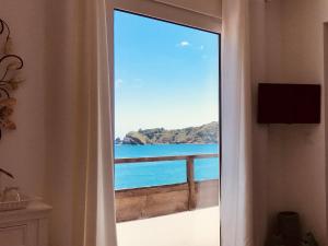 a view of the ocean from a room with a window at A Villa by the Sea Bed & Breakfast in Vila Franca do Campo
