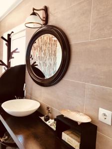 a bathroom with a sink and a mirror at A Villa by the Sea Bed & Breakfast in Vila Franca do Campo