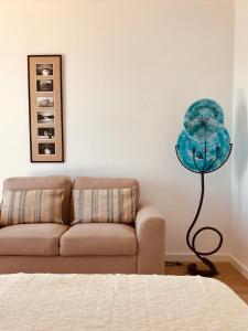 a lamp in a living room next to a couch at A Villa by the Sea Bed & Breakfast in Vila Franca do Campo