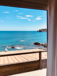 a view of the ocean from a window at A Villa by the Sea Bed & Breakfast in Vila Franca do Campo