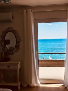 a view of the ocean from a bedroom window at A Villa by the Sea Bed & Breakfast in Vila Franca do Campo