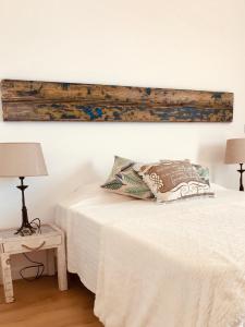 a bedroom with a bed with a wooden board above it at A Villa by the Sea Bed & Breakfast in Vila Franca do Campo