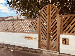 a wooden fence with a sign on it at A Villa by the Sea Bed & Breakfast in Vila Franca do Campo