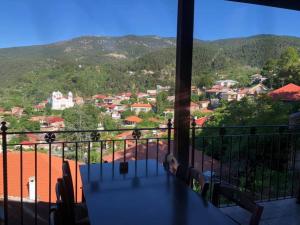 
a view from a balcony overlooking a city at Mountain Rose Garden Hotel & Restaurant in Pedoulas
