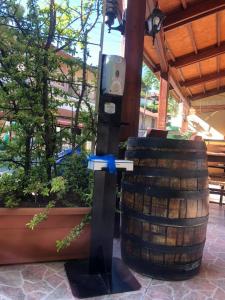 
a bottle of water sitting on top of a wooden pole at Mountain Rose Garden Hotel & Restaurant in Pedoulas
