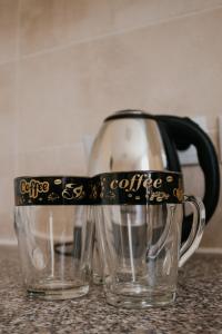 a coffee mug with a black handle sitting on a counter at Хостел на Баварии in Kharkiv +25 photos