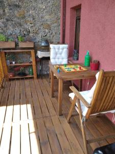 a wooden table and a chair on a patio at Can Mieta in Bas