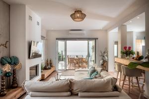 a living room with a couch and a table at Domus Aqua in Kato Daratso +17 photos