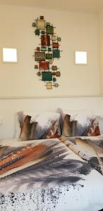 a bedroom with a bed with a picture on the wall at In Den Visser in Dordrecht