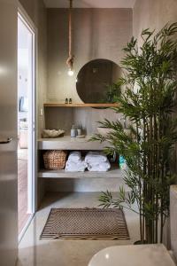 a bathroom with a sink and a plant at Glaros Luxury Villa in Kato Daratso