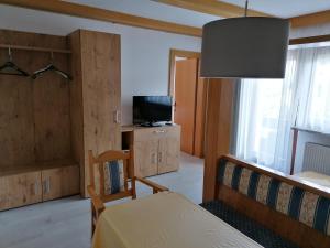 a bedroom with a bed and a tv in a room at Landhaus Relly in Seefeld in Tirol