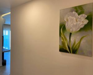 a painting of a white flower on a wall at Zest Exclusive Hotel & Spa in Ortakent