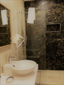 a bathroom with a white sink and a shower at Zest Exclusive Hotel & Spa in Ortakent