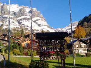 a sign in front of a mountain at B&B Pension Rustica in Inden