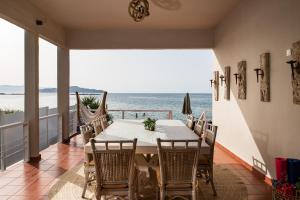 a dining room with a table and a view of the ocean at Domus Aqua in Kato Daratso