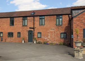 a red brick building with a driveway in front at 1 Fox Studios in Much Wenlock