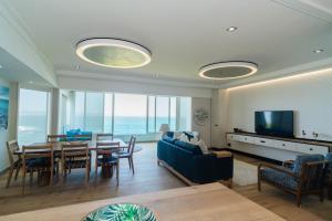 a living room with a table and a dining room at Bayview 303 in Hermanus