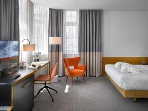 a hotel room with a bed and a desk and a computer at K+K Hotel Fenix in Prague