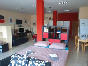 a bedroom with a bed and a living room at BAILANDO Studio in Neratovice