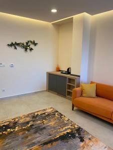 a living room with an orange couch and a table at Zest Exclusive Hotel & Spa in Ortakent