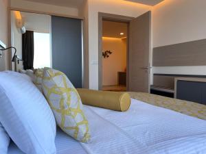a bedroom with a large bed with white pillows at Zest Exclusive Hotel & Spa in Ortakent