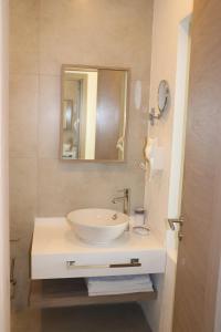 a bathroom with a white sink and a mirror at Zest Exclusive Hotel & Spa in Ortakent