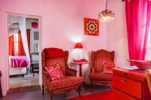 a room with two chairs and a table and a bed at The Artist's Cottage in Prince Albert +41 photos