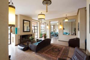 a living room with a couch and a fireplace at Ecolodge Quaryati Marrakech in Douar Tounsi