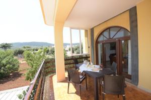 a patio with a table and chairs on a balcony at Casa Vacanze TITINA HOME in Montalbano