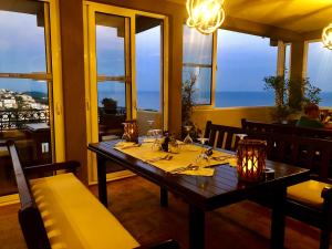 a table in a restaurant with a view of the ocean at Apartments Tati in Ulcinj