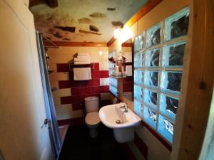 a small bathroom with a sink and a toilet at Galicia Retreat in Santa Marta de Ortigueira +95 photos