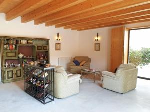 a living room with two chairs and a table at Casa das Hortênsias in Alijó