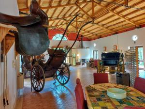 a carriage on display in a room with a table at Chiosi Country Club in Corleone