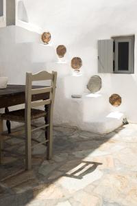 a wooden chair sitting at a table in a room at Chora Anargyros in Ios Chora