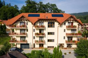 an apartment building with solar panels on its roof at Pensiunea Comfort in Sovata