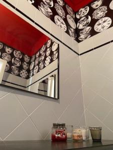 a mirror on a wall above a counter in a kitchen at Hotel Mambo in Laigueglia +59 photos